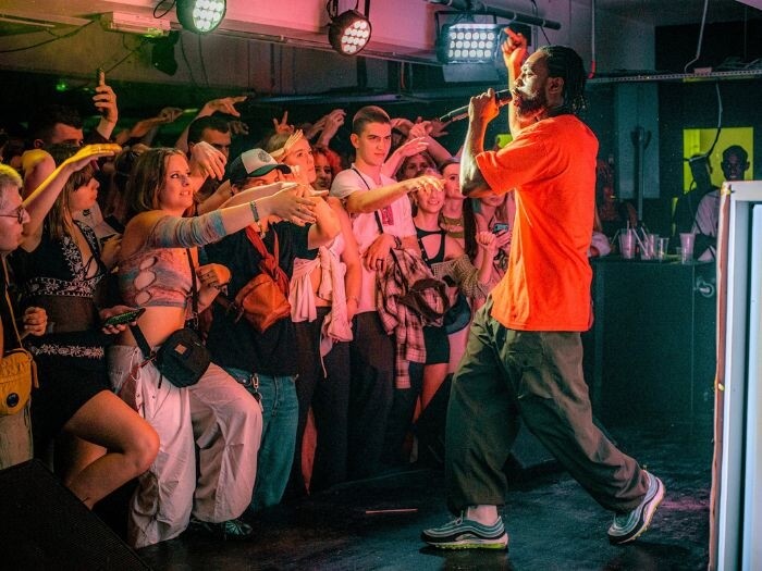 Musician performing in front of the crowd at Peckham Levels