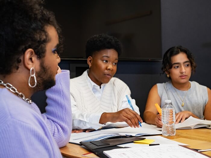 A group of co-workers of varying genders having a meeting.